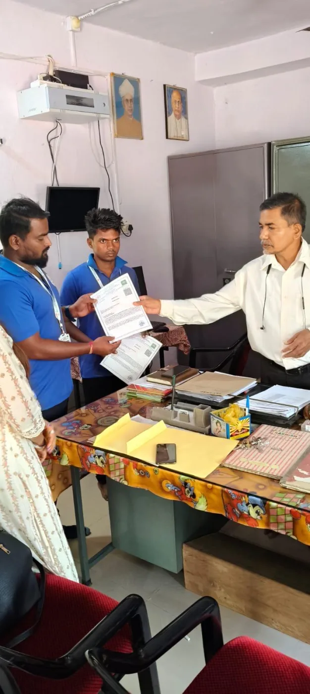 Association representatives presenting a certificate to a student in an office.