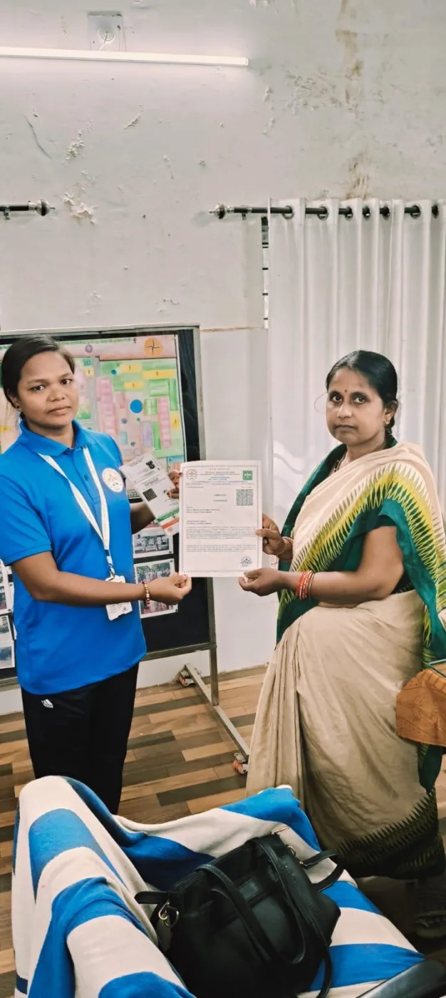 A young participant being recognised by association members indoors.