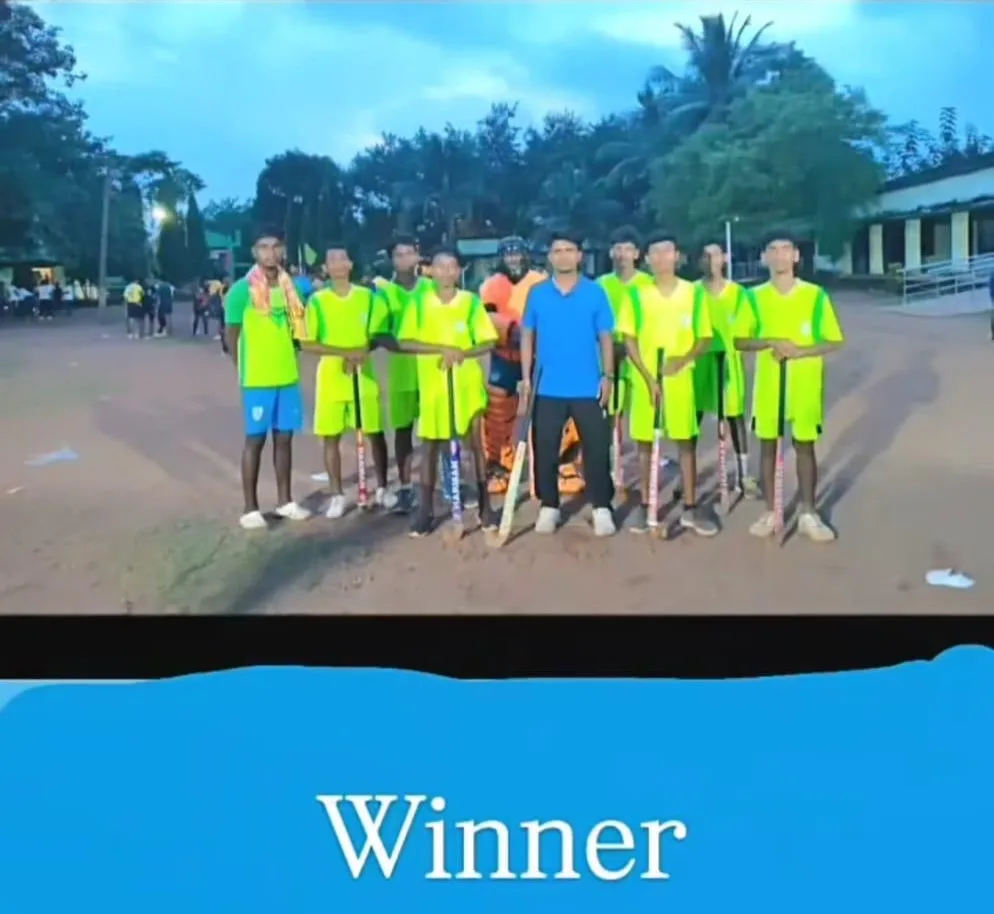 A winning student team in green uniforms posing on a sports ground.