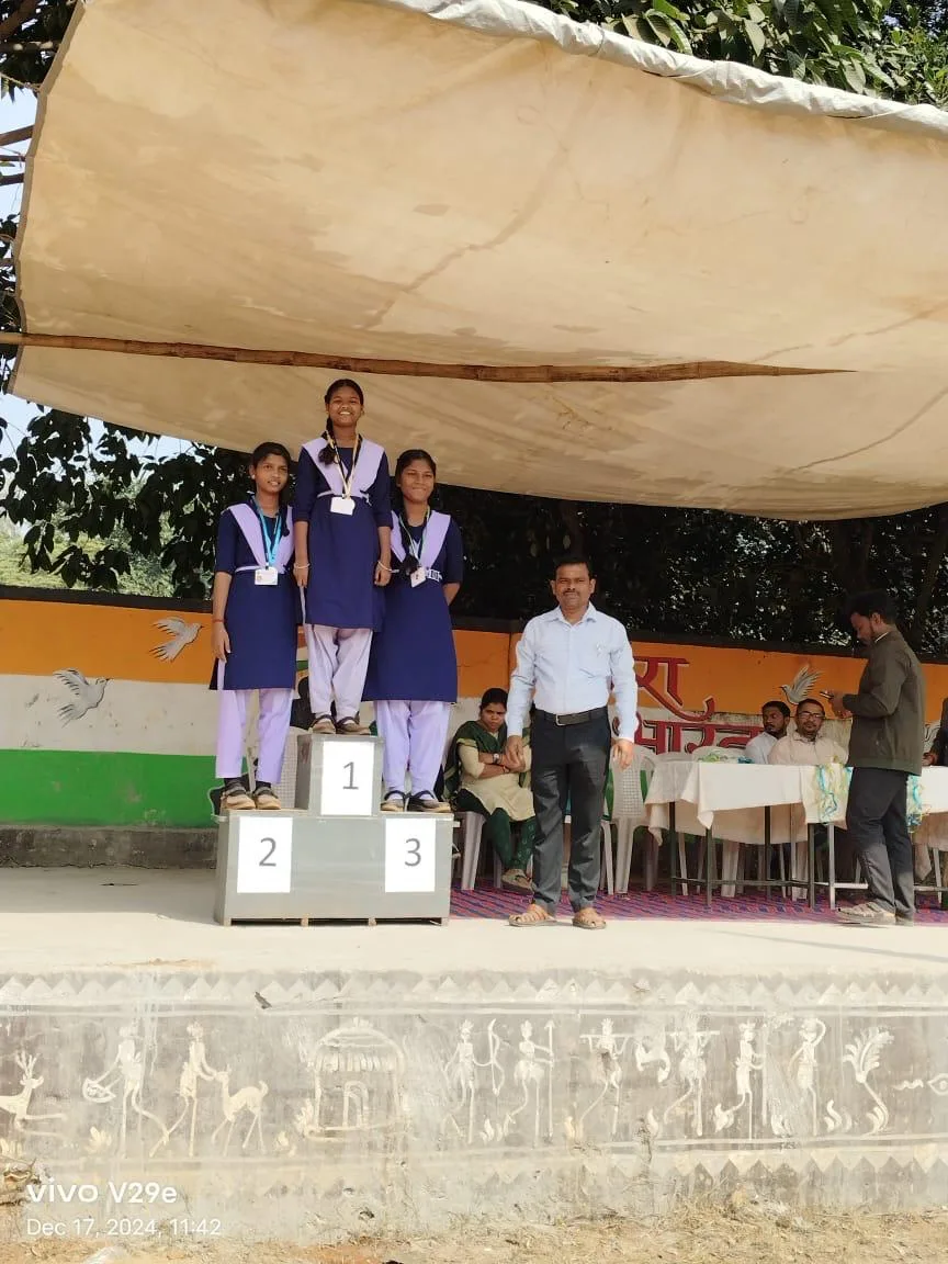 Girl students standing on a winners podium after a sports event.