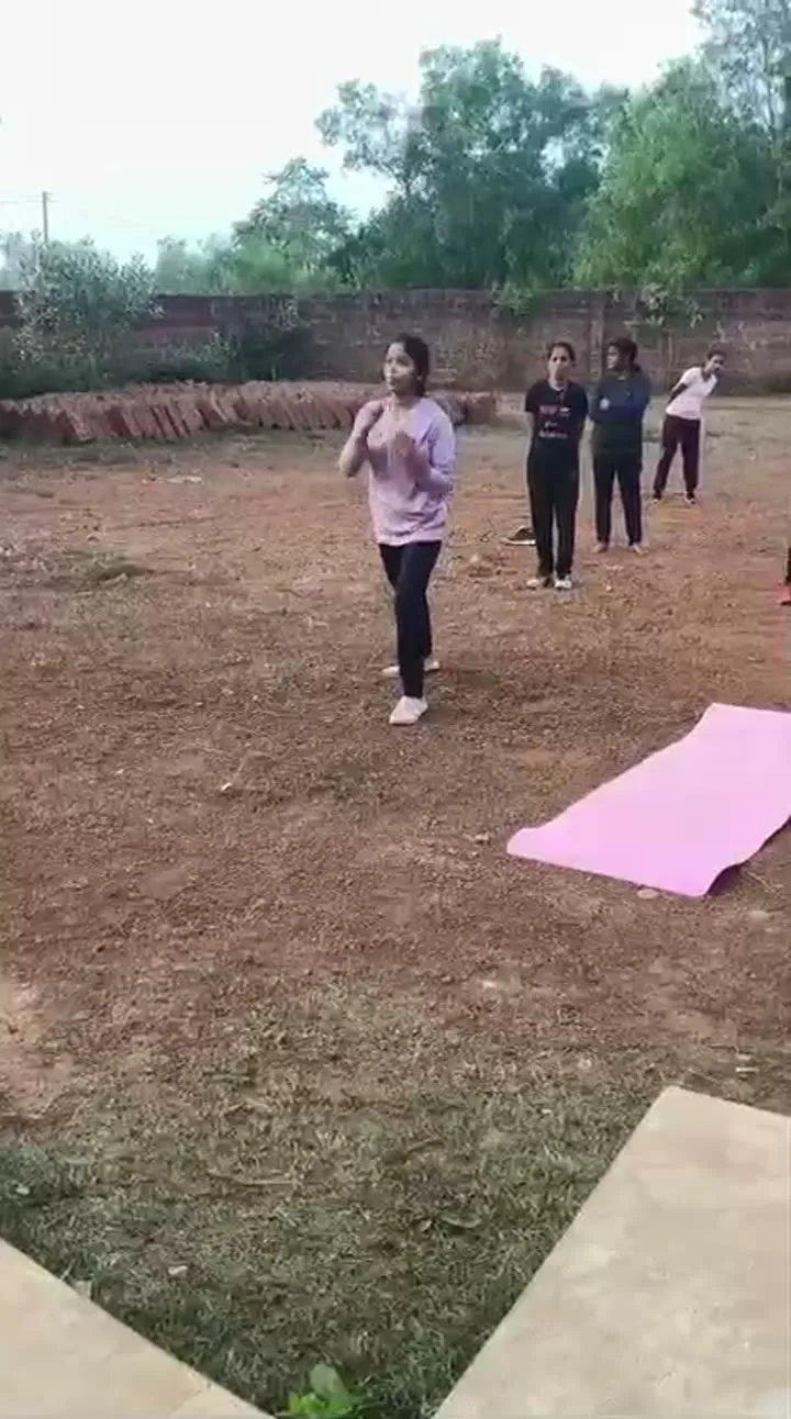 Students taking part in an outdoor warmup and field activity.
